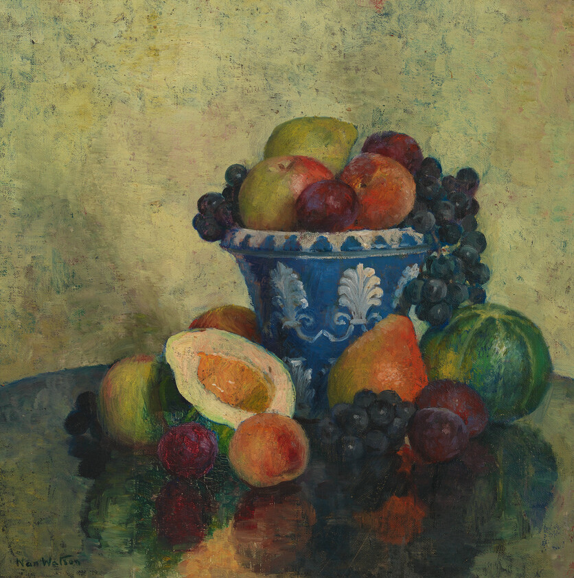 A blue decorative bowl filled with apples, grapes, and pears beside sliced peach and melon.
