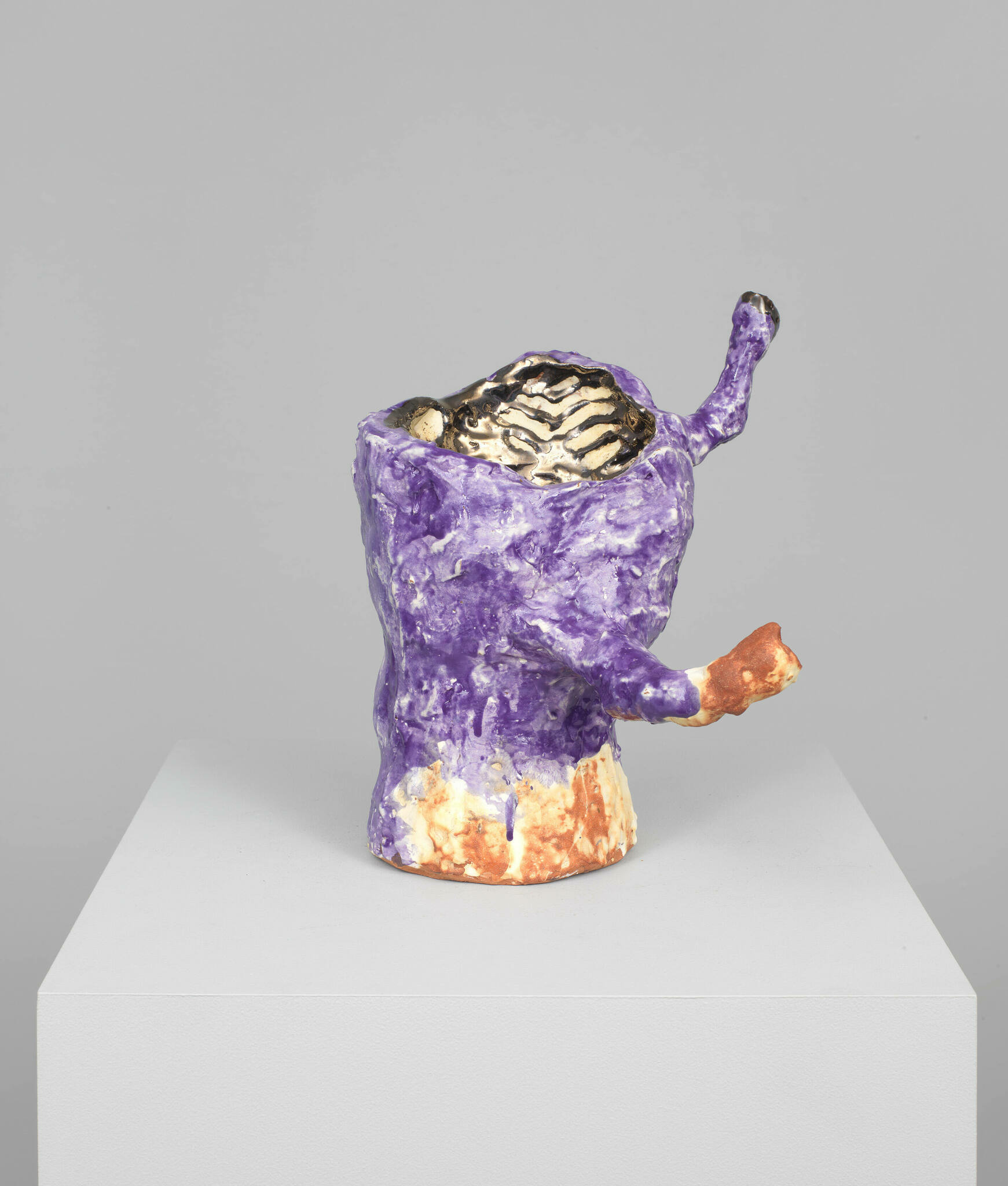 Corporeal red clay sculpture in a roughly finished purple glaze and metallic gold interior with two skinny protruding armatures