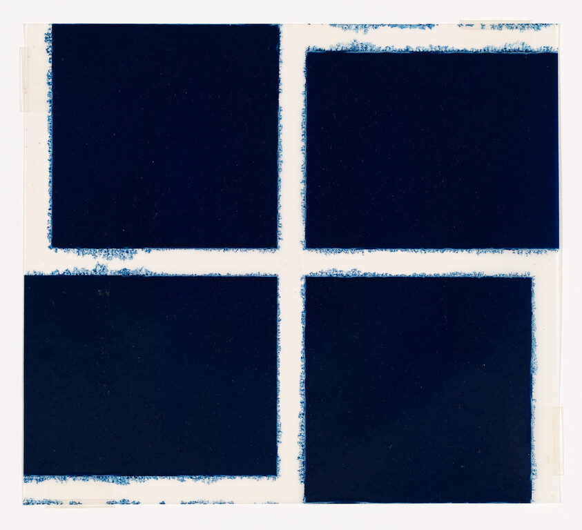 Four dark blue squares arranged in a two-by-two grid with white borders and rough edges.