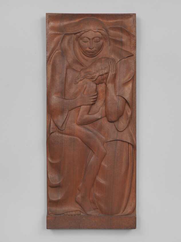 A seated woman gently holding a small child close to her chest.