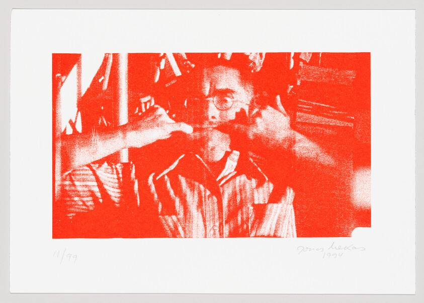 A red monochromatic print depicting a person with glasses holding their hands to their face in a thoughtful or contemplative pose. The image has a textured, grainy quality and is surrounded by a white border. In the bottom left corner, there is a fraction "11/99" indicating the print number, and in the bottom right corner, there is a signature followed by the year "1994."