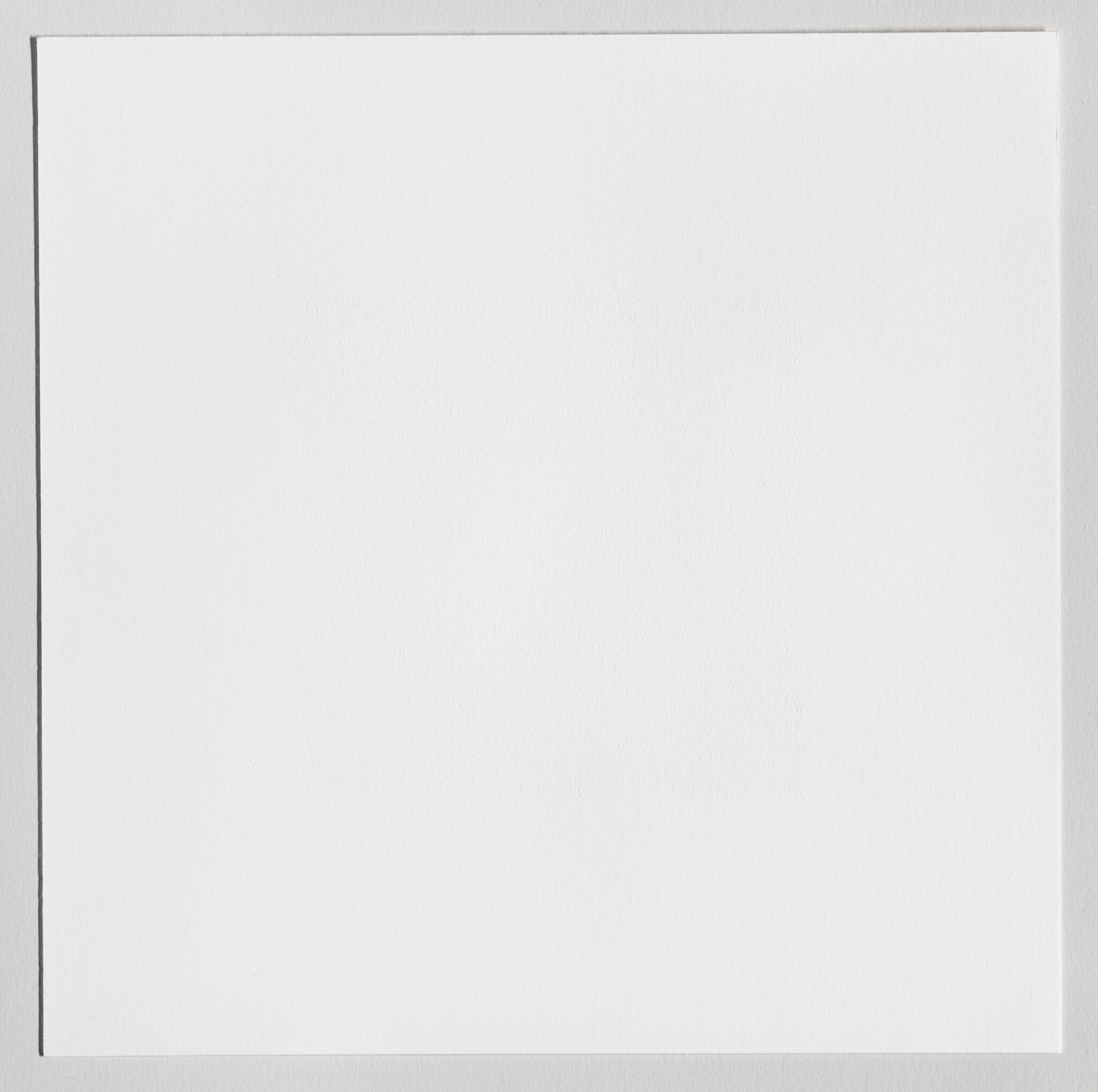 Square sheet of white textured paper centered on a light gray background with thin shadow.