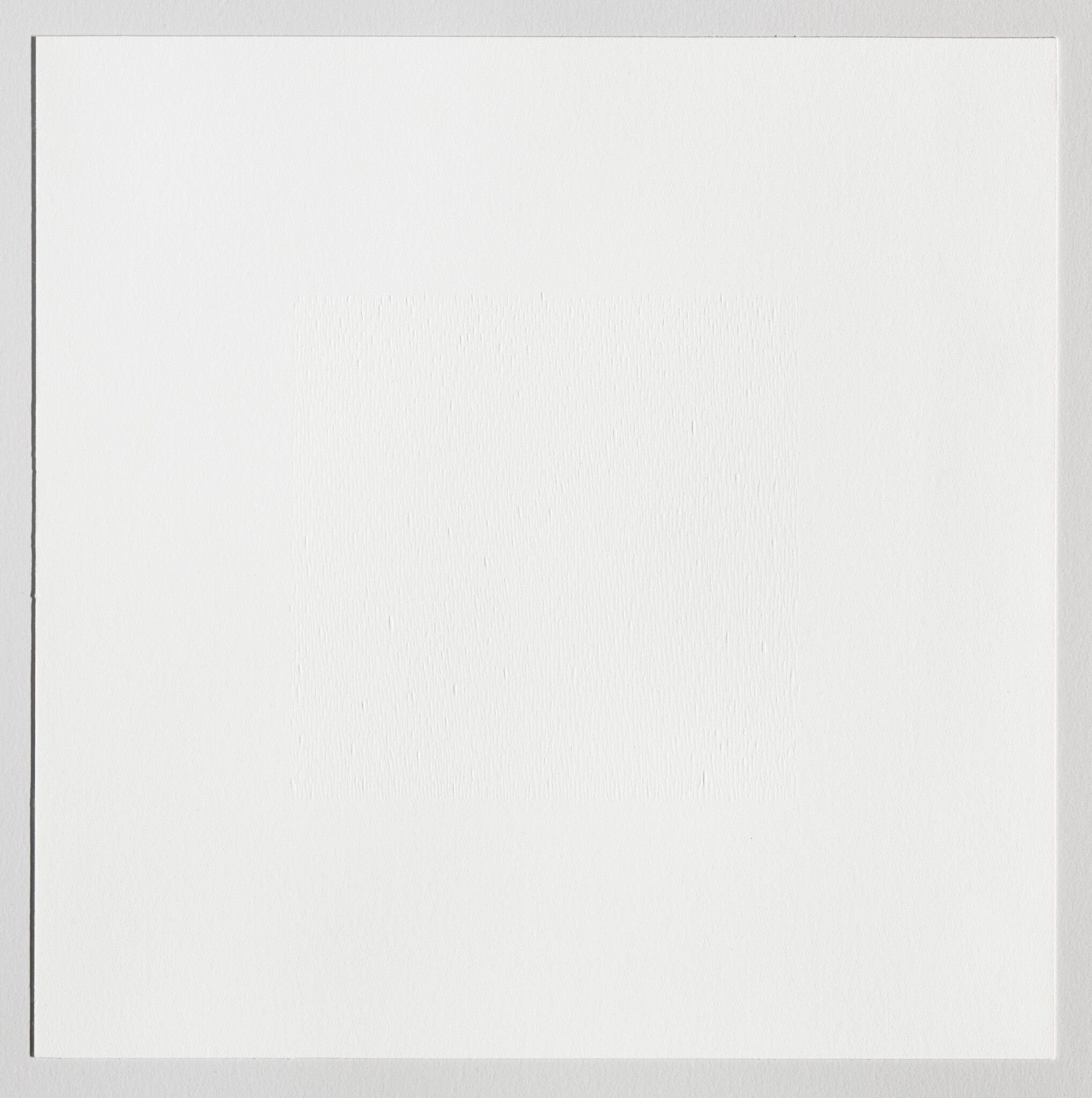 A blank textured white paper with a subtle embossed square in the center and thin border.