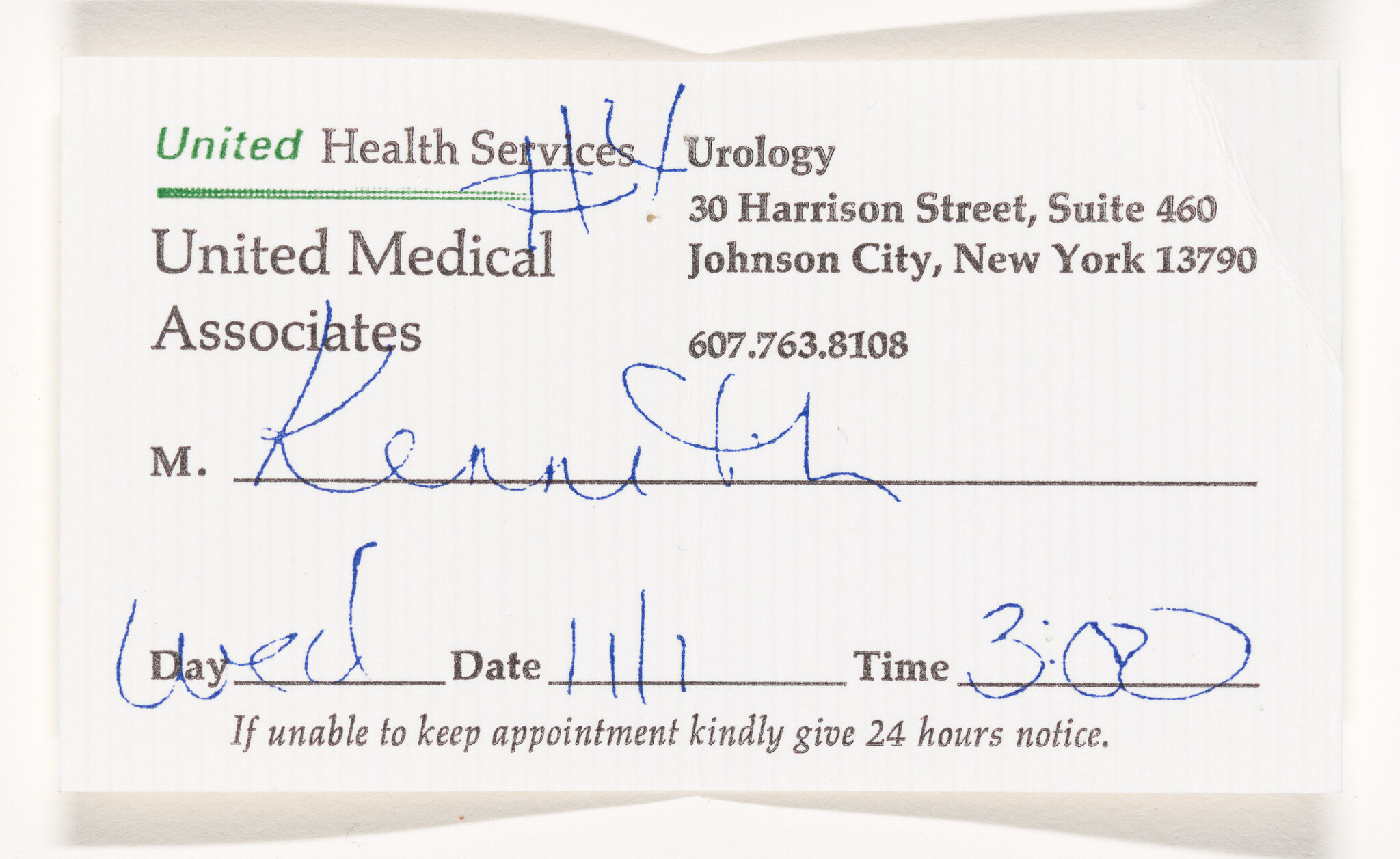 A crumpled appointment reminder card from United Health Services, Urology at United Medical Associates with handwritten notes indicating a scheduled appointment time at 3:00, with the date and day sections left blank. The card also includes the address in Johnson City, New York, and a phone number. There is a reminder at the bottom requesting a 24-hour notice if the appointment cannot be kept.