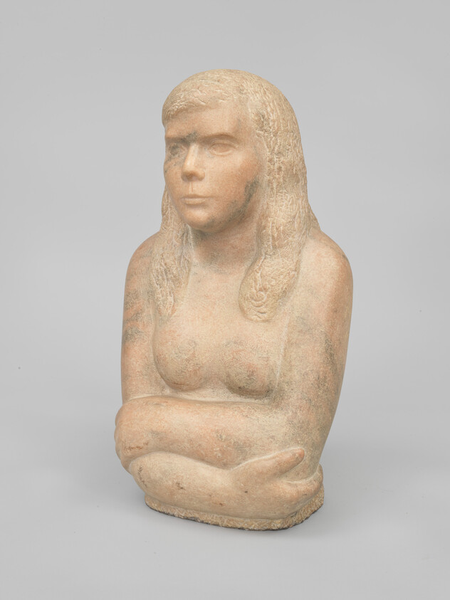 Stone sculpture of a seated woman with long hair and crossed arms.