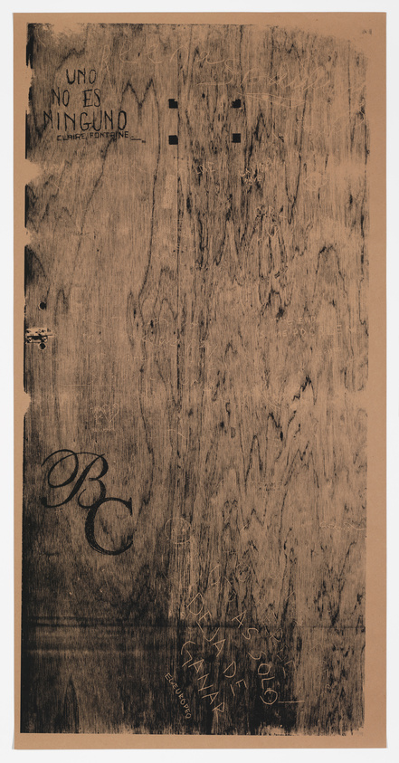 A textured artwork resembling a scratched wooden surface with various inscriptions and markings, including the phrases "UNO NO ES NINGUNO" and "EL CUBOYTO," along with other illegible scribbles and large, stylized initials. The piece has a sepia tone and is bordered by a lighter frame.