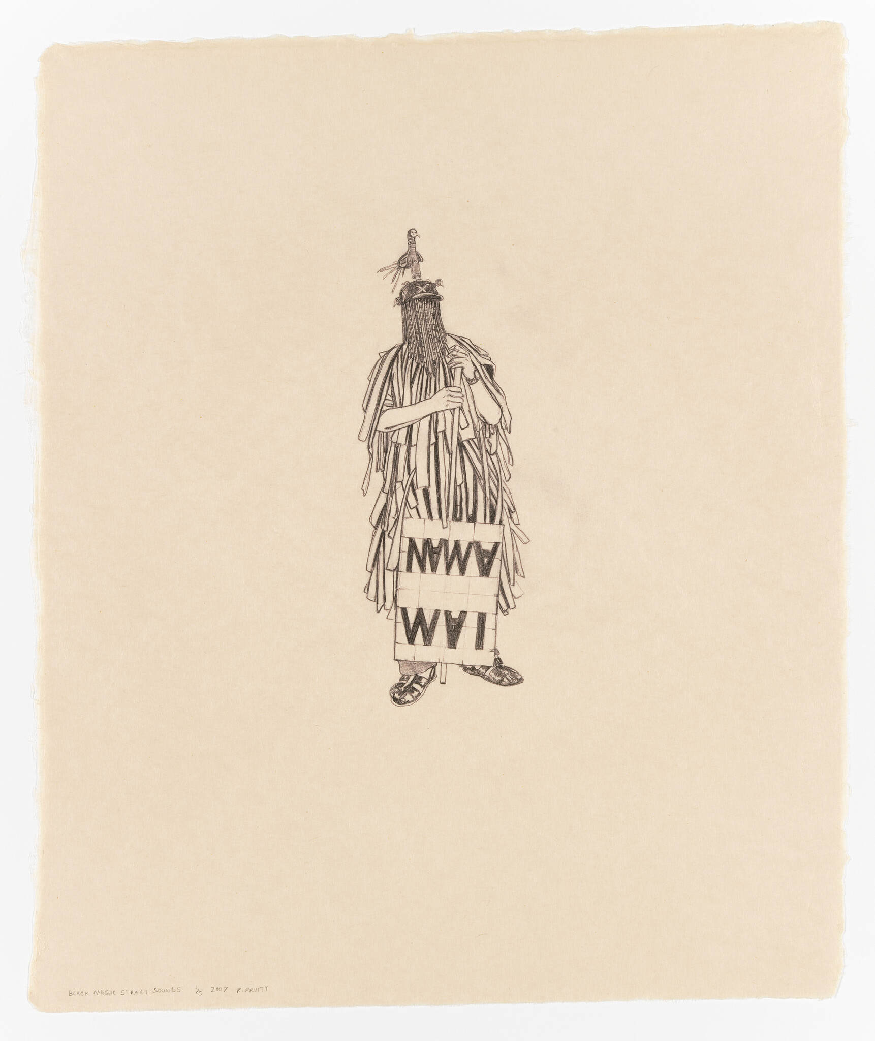 A person in a fringed costume and beaded face mask holds a pole and a sign reading "I AM MAN".