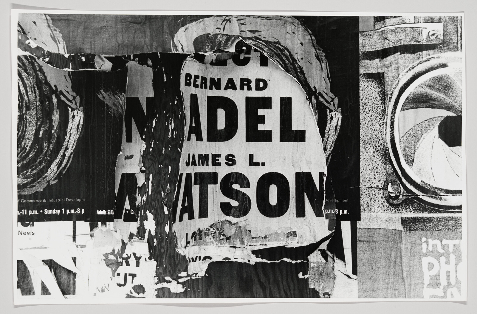 Torn layered posters with large bold blocked letters and peeling paper revealing partial words.