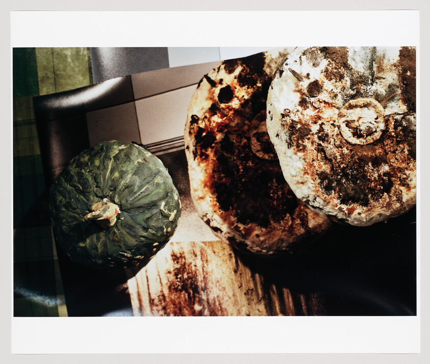 Three round winter squashes with rough, mottled skins resting on a tabletop.