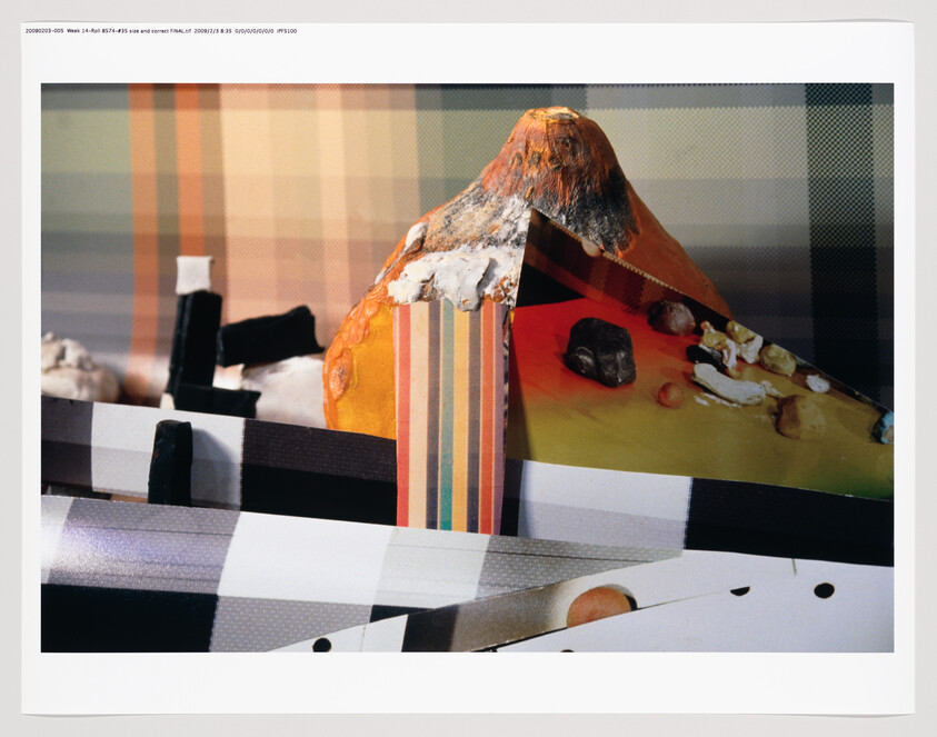 A photograph of a mixed media art piece featuring abstract elements, with a prominent orange and yellow triangular shape that appears to be a three-dimensional object with a textured surface. The background consists of various geometric patterns and halftone gradients, suggesting a digital manipulation or collage technique. The image includes a watermark or text overlay at the top with technical details about the file.