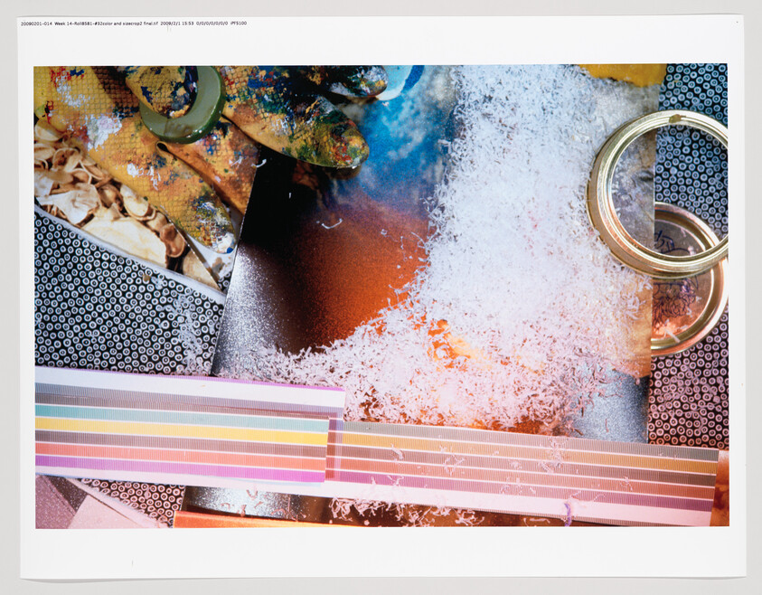 A colorful collage with a paint-splattered glove, shredded white material, striped tape, and metal rings.