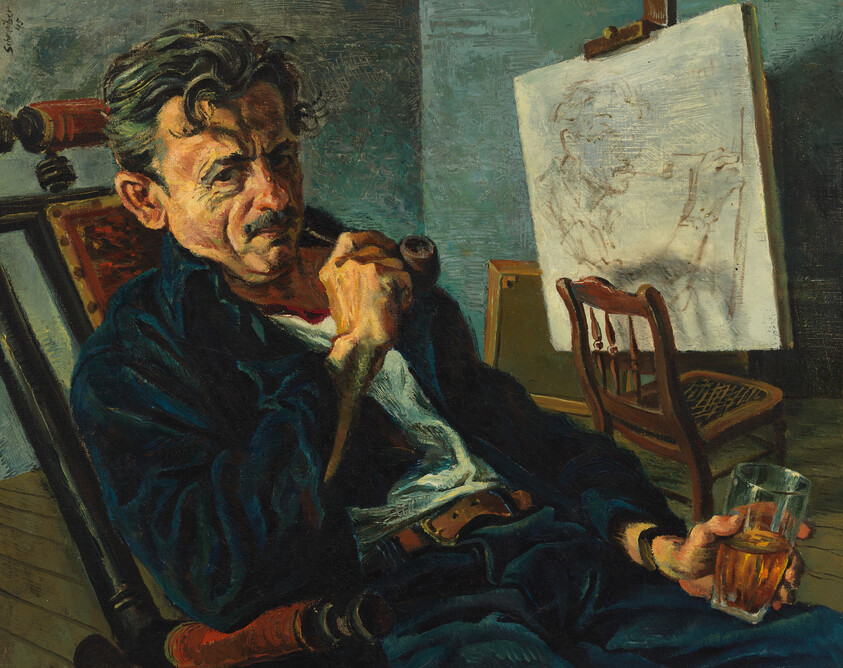 A tired man sits in a studio chair smoking a pipe and holding a glass.