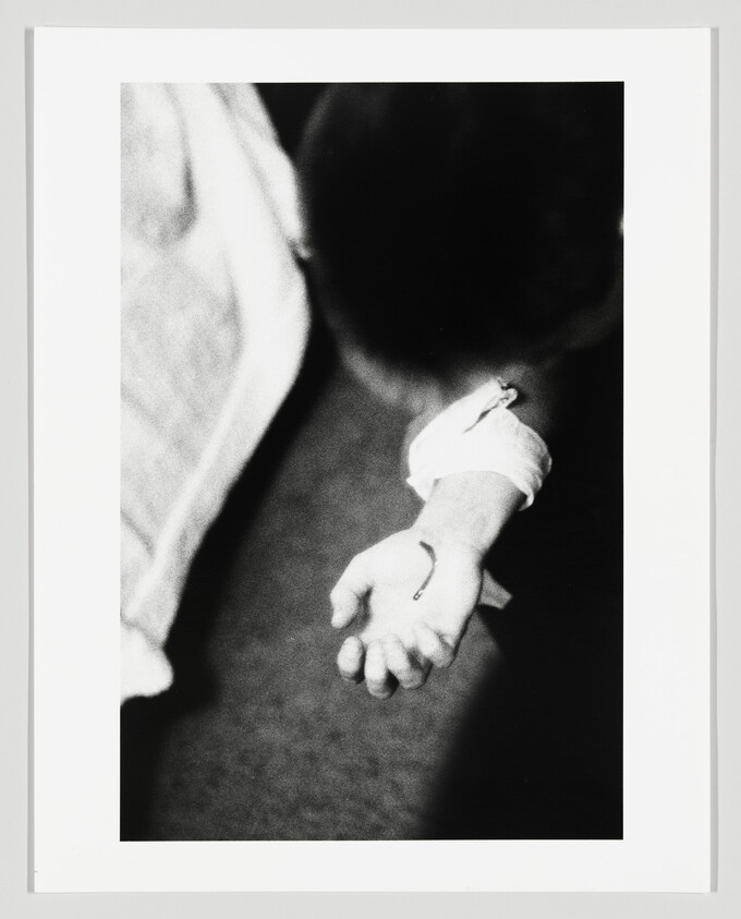 A child’s hand extended with a small fish hook caught in the palm.