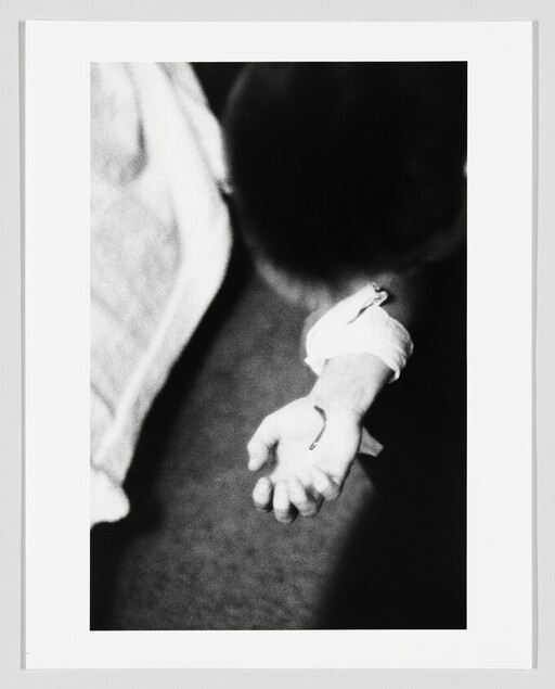 A child’s hand extended with a small fish hook caught in the palm.