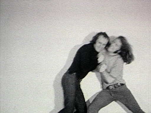 Two people grappling closely, one person holding the other's neck in a struggle.