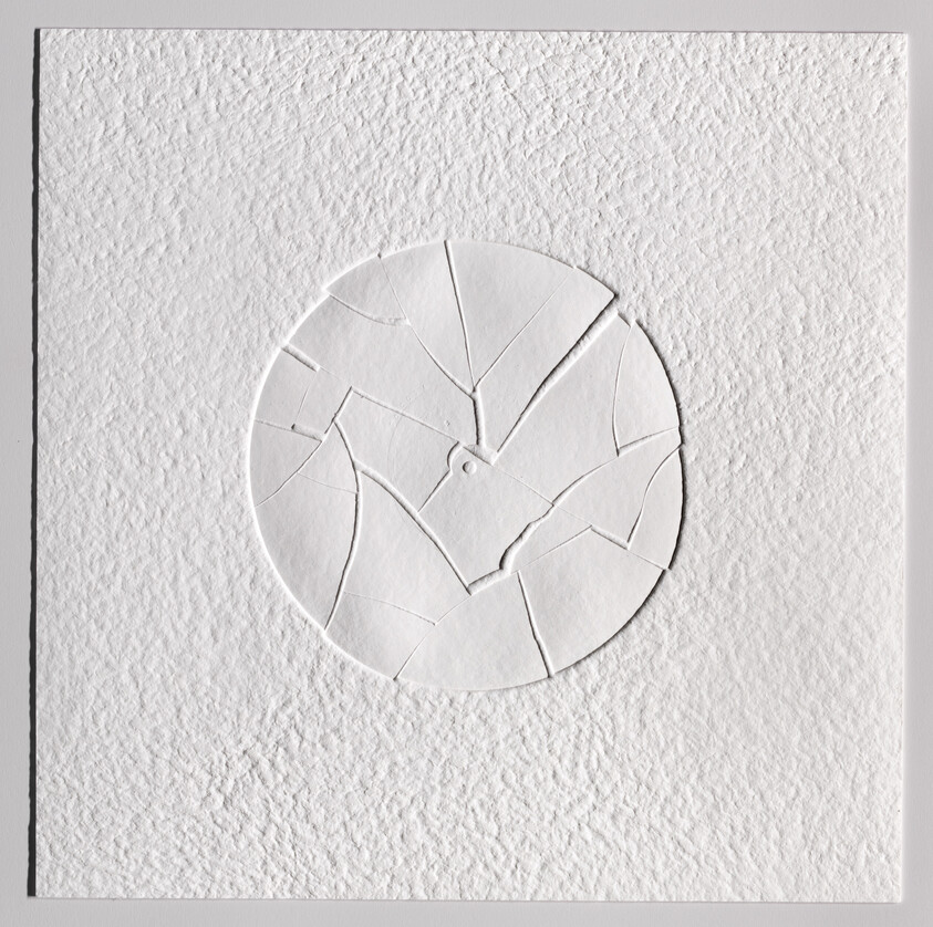 Circular cracked plaster art centered on a rough white textured square background.