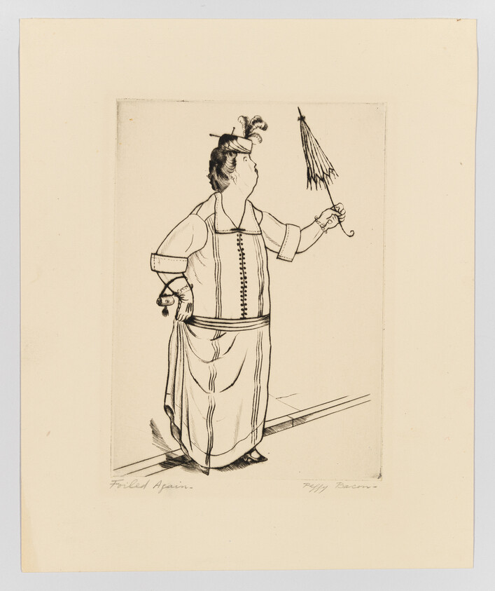 A woman in an early 20th-century dress and small hat holds a closed umbrella while standing.