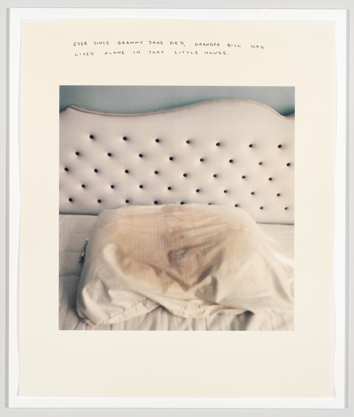 A white tufted headboard with a stained pillow and rumpled sheets suggesting absence.