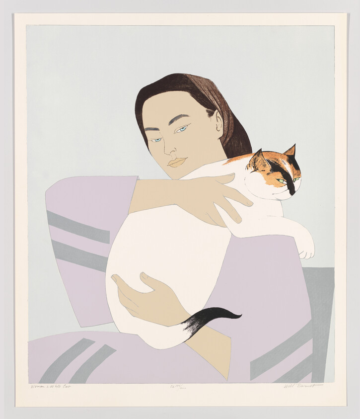 A woman gently holding a large calico cat in her arms.