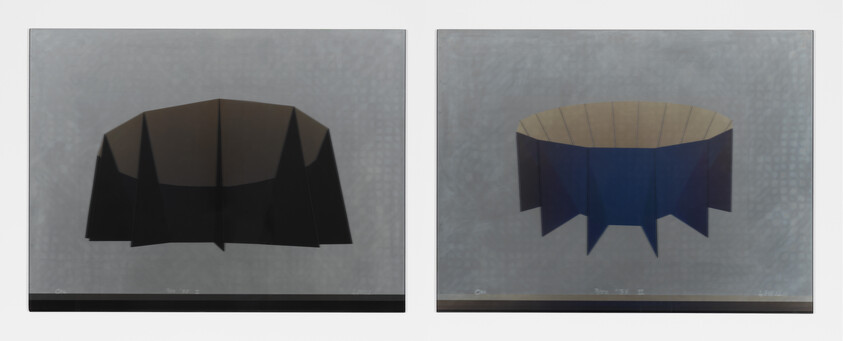 Two folded paper models showing a dark faceted dome on the left and a blue ring-shaped model on the right.