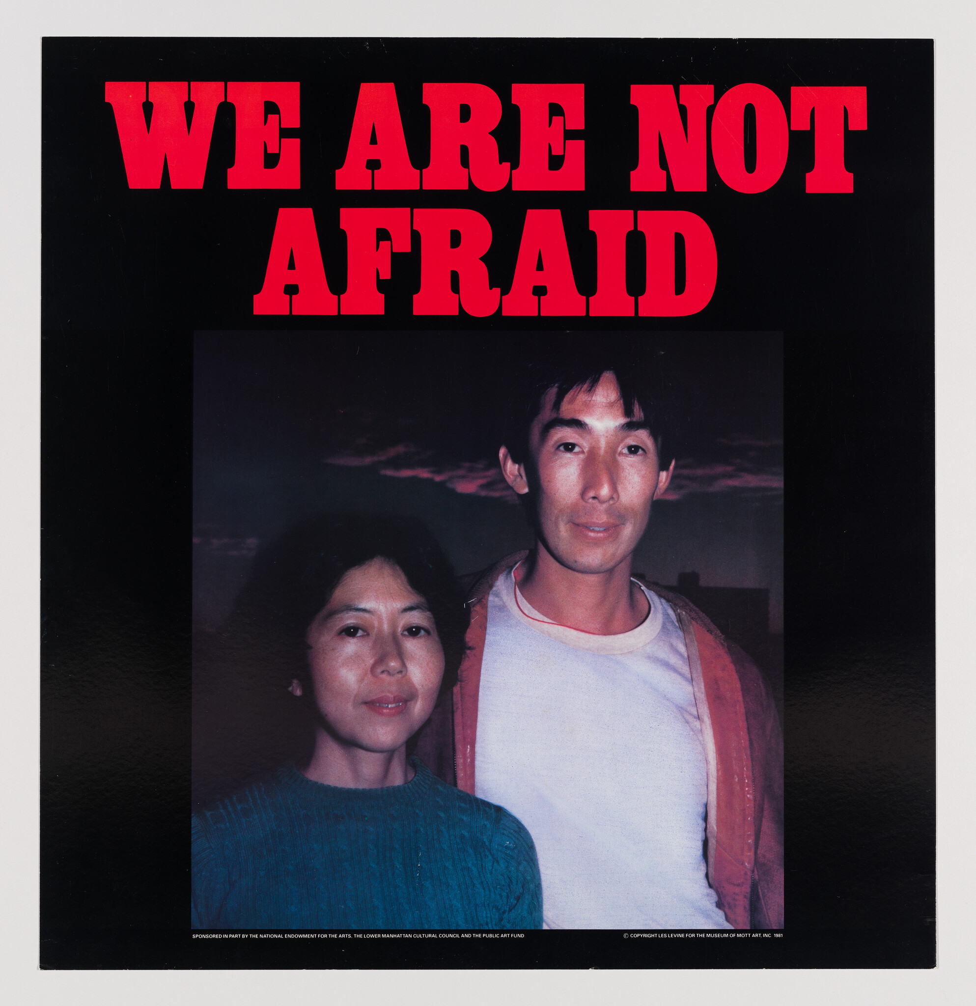 A man and woman stand together beneath bold red text reading "WE ARE NOT AFRAID."