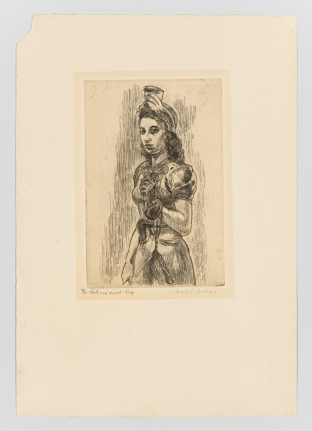 A young woman in a historical dress stands holding a small flower to her chest.