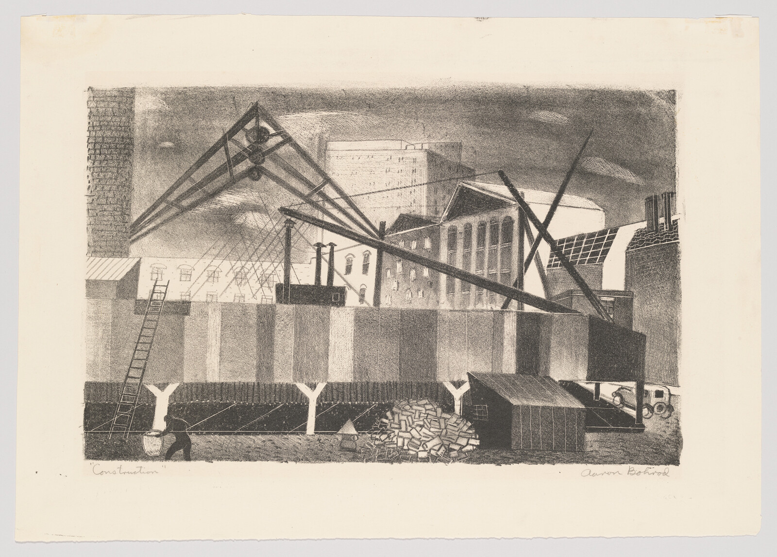 Construction site with cranes, scaffolding, worker carrying a bucket and piles of bricks.