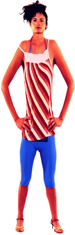 Young woman stands with hands on hips wearing a striped tank top and blue capri leggings.