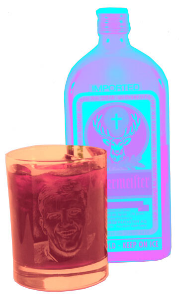 A filled glass tumbler sits in front of a tall liqueur bottle displaying a deer logo.