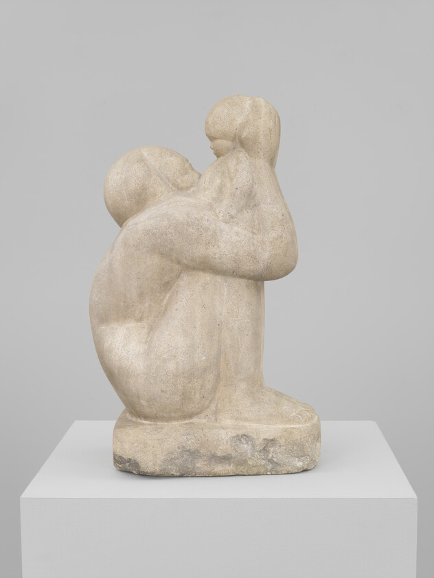 Stone sculpture of an adult kneeling and lifting a child to their face.