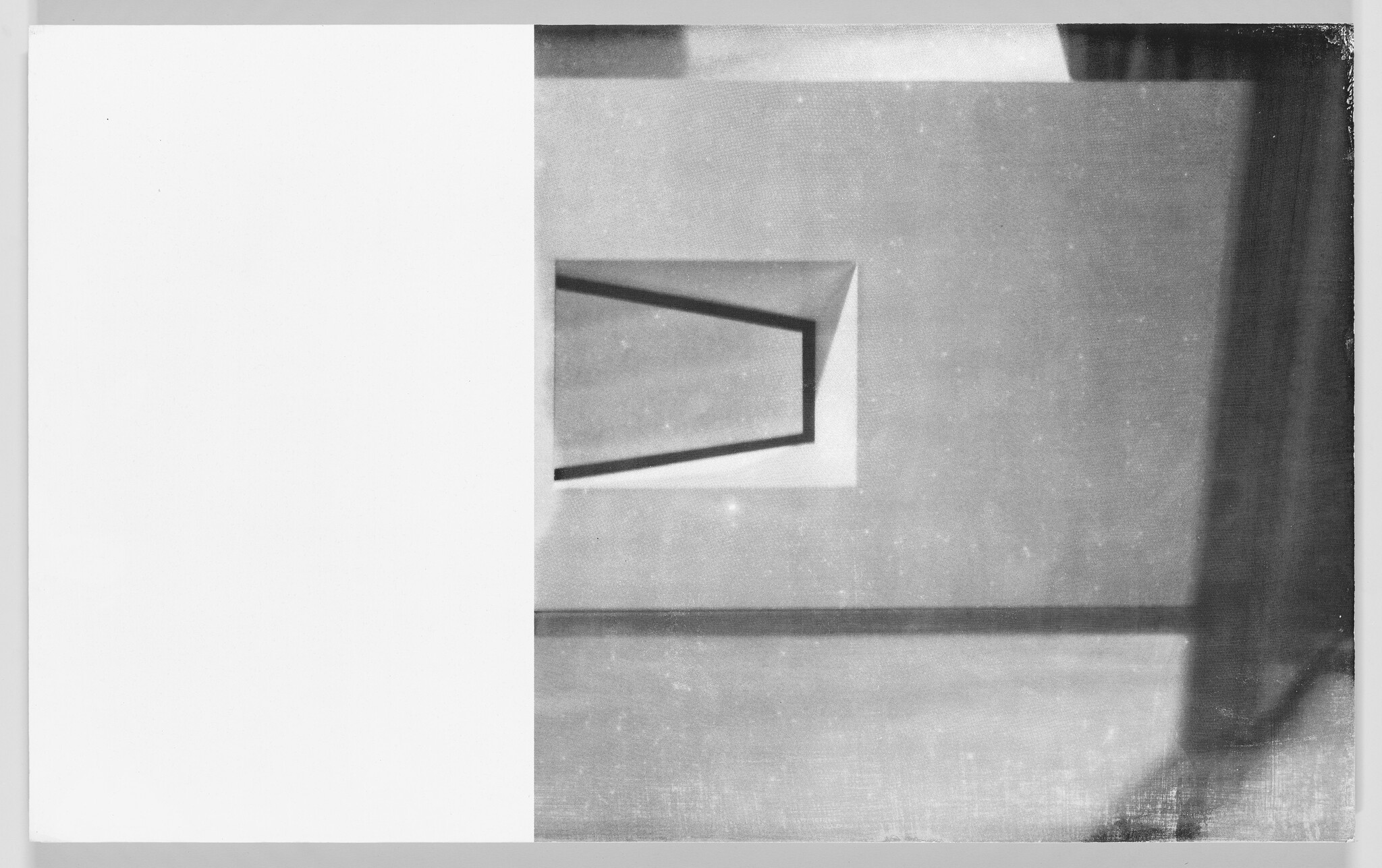 Blank white panel beside a textured wall with a small trapezoid window casting shadows.