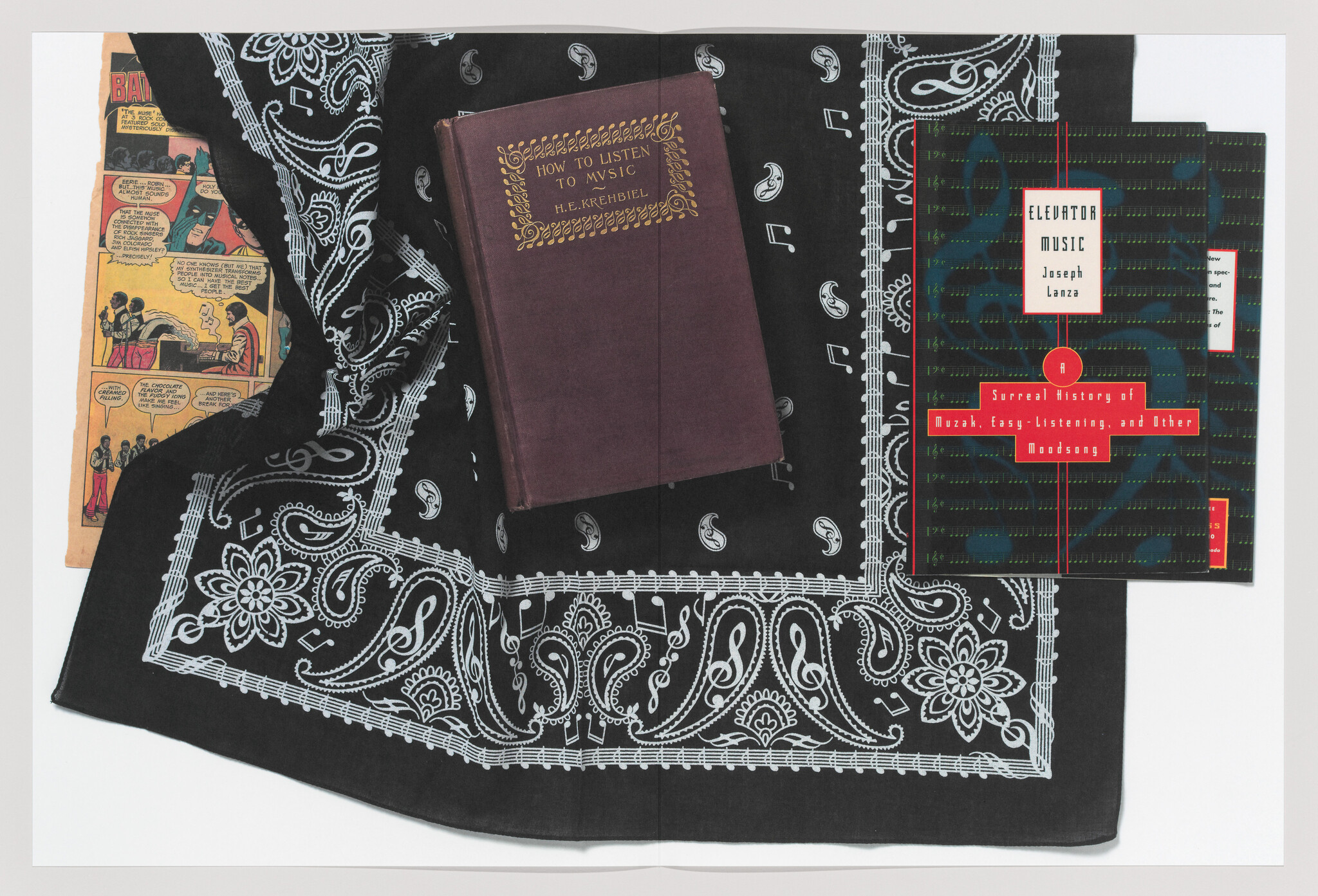 A black paisley bandana holds two music books, one titled How to Listen to Music, beside a comic strip.