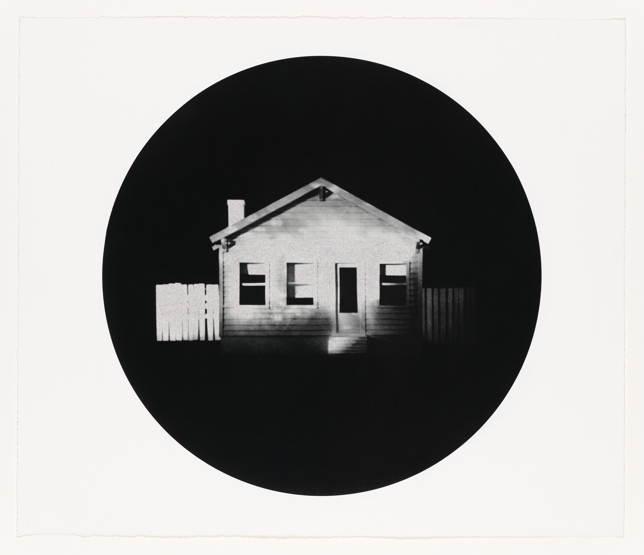 Small single-story house with lit front door and white picket fences centered in a dark circle.