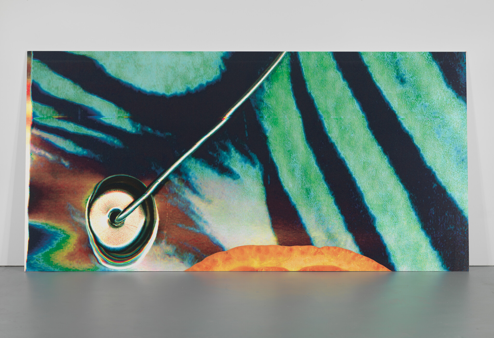 Large colorful abstract panel with green and black stripes and a metal rod attached to a circular base.