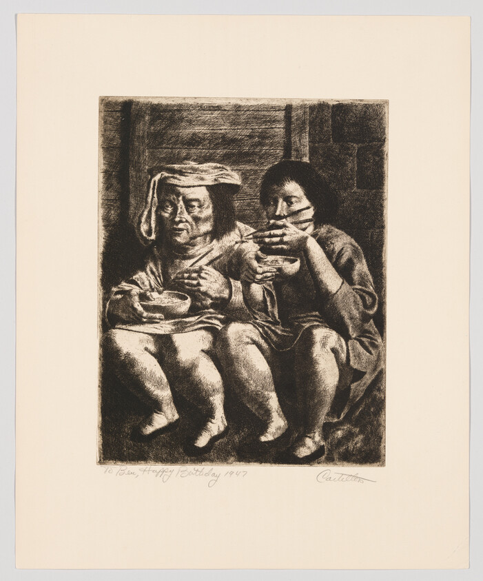 Two seated children eat from bowls, one wearing a cloth on their head.