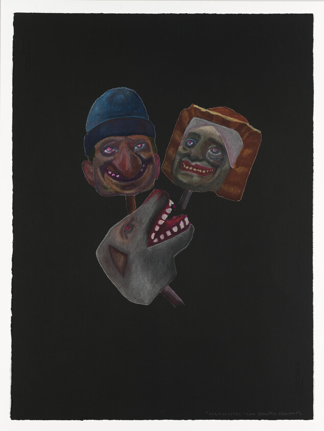 Three carved puppet heads on sticks, including a dog head and two human faces, set against black.