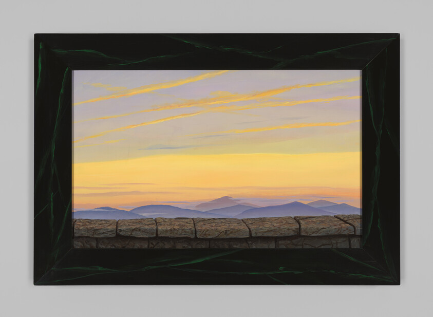 Framed painting showing a golden sunrise over layered purple mountains seen above a stone ledge.