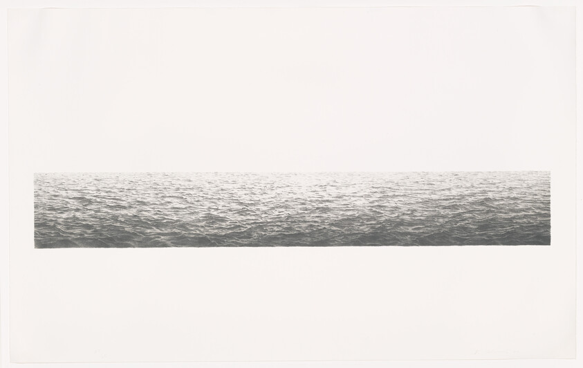 A long narrow strip of calm ocean water stretching horizontally across a wide white background.