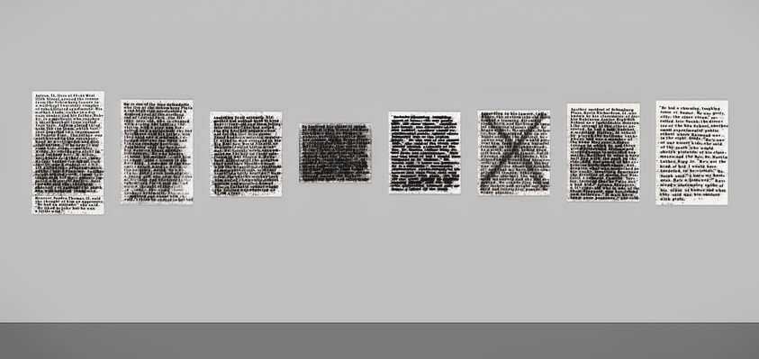 Eight framed text panels with heavy redactions and an X mark displayed in a row on a gray wall.