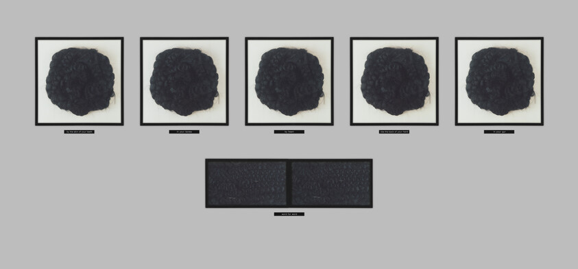 Five framed dark textured circular sculptures above two rectangular panels, each with small labels beneath.