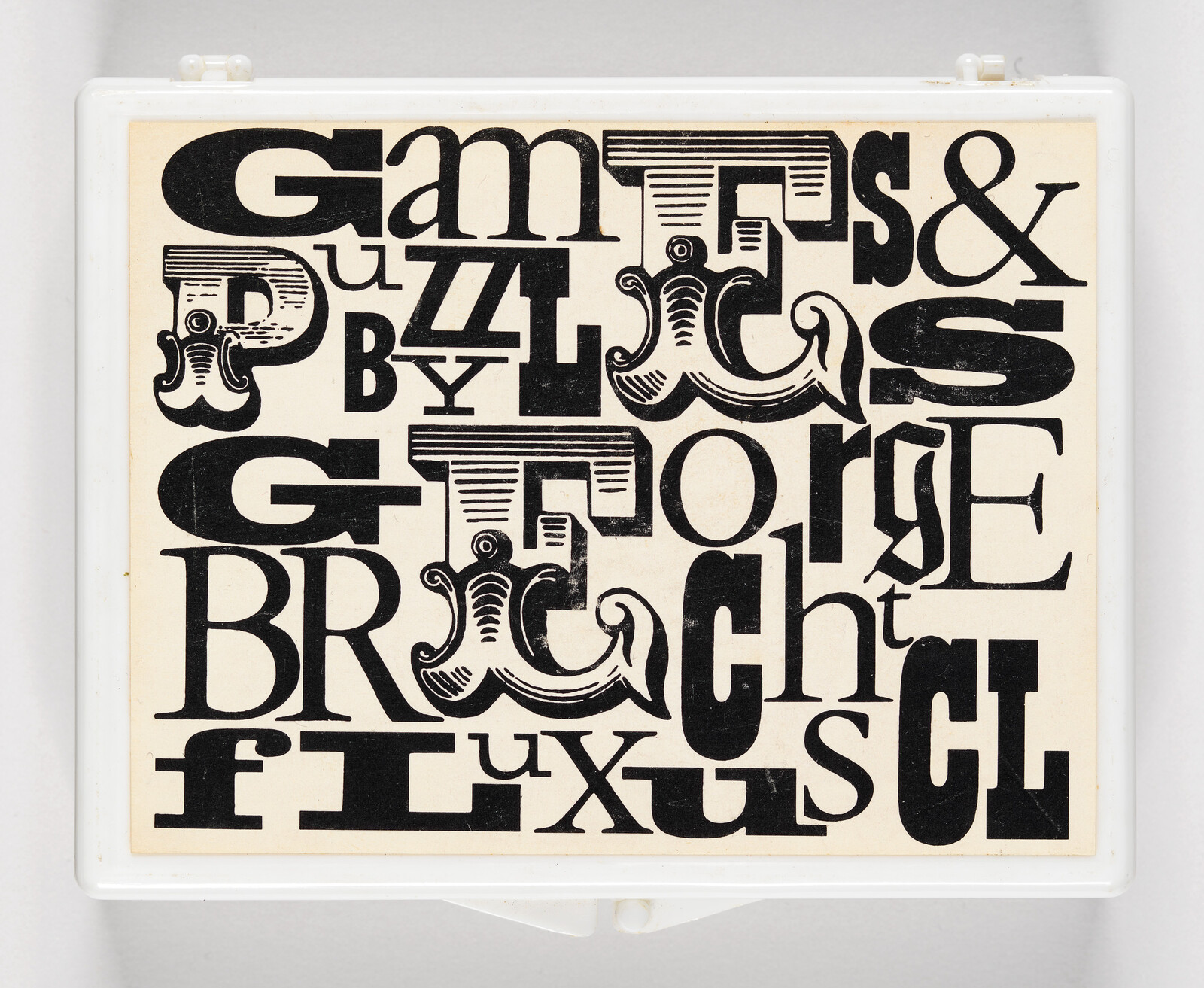 Black and white typographic puzzle with stylized letters and ampersand, encased in a white frame.