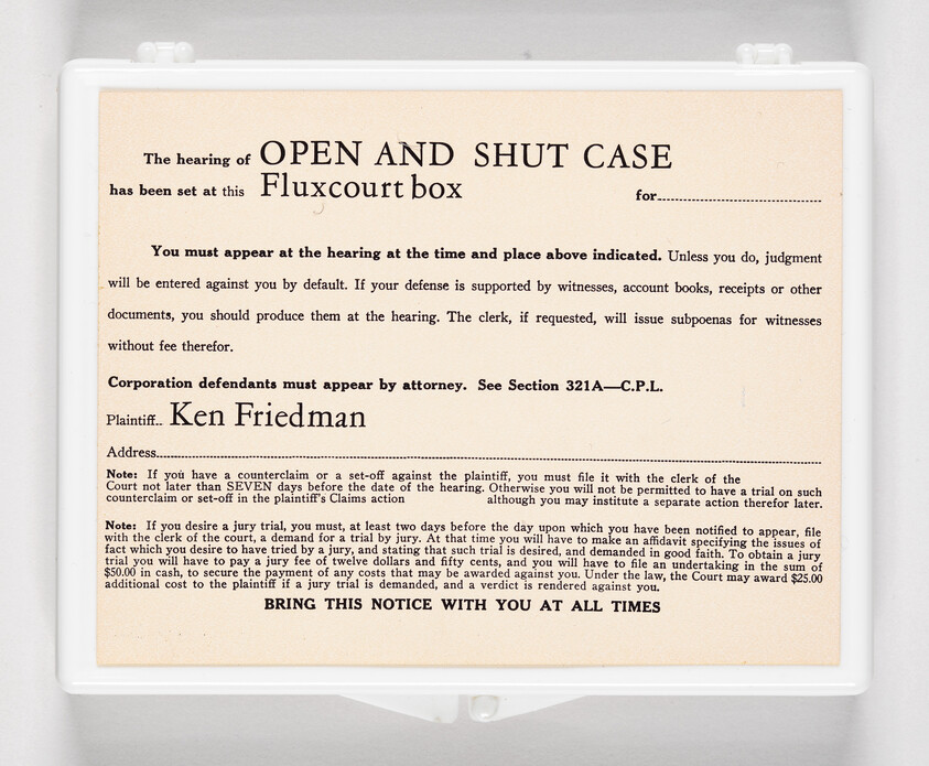 A legal hearing notice titled "Open and Shut Case" posted inside a clear box.