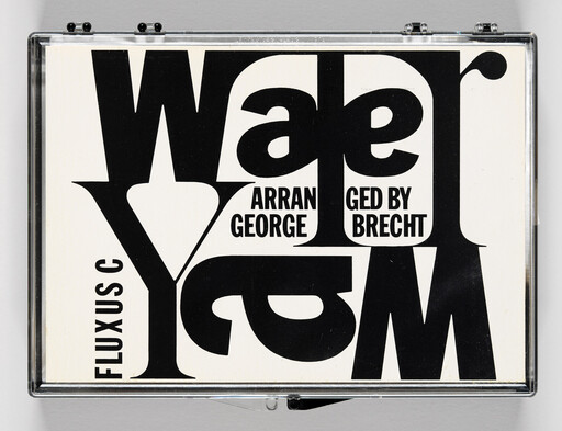 Clear plastic cassette case with bold black typographic cover reading arranged by George Brecht and Fluxus.