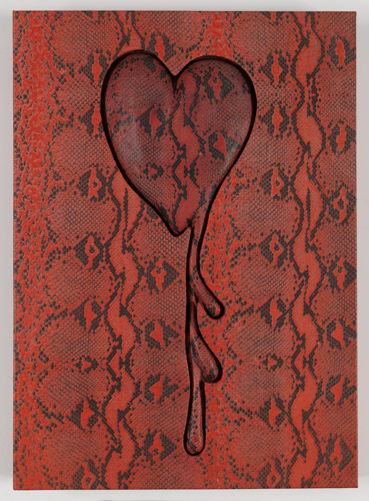 A textured artwork featuring a stylized black heart outline against a red and black patterned background that resembles snake skin. The heart appears to be dripping, with the drips extending towards the bottom of the image.