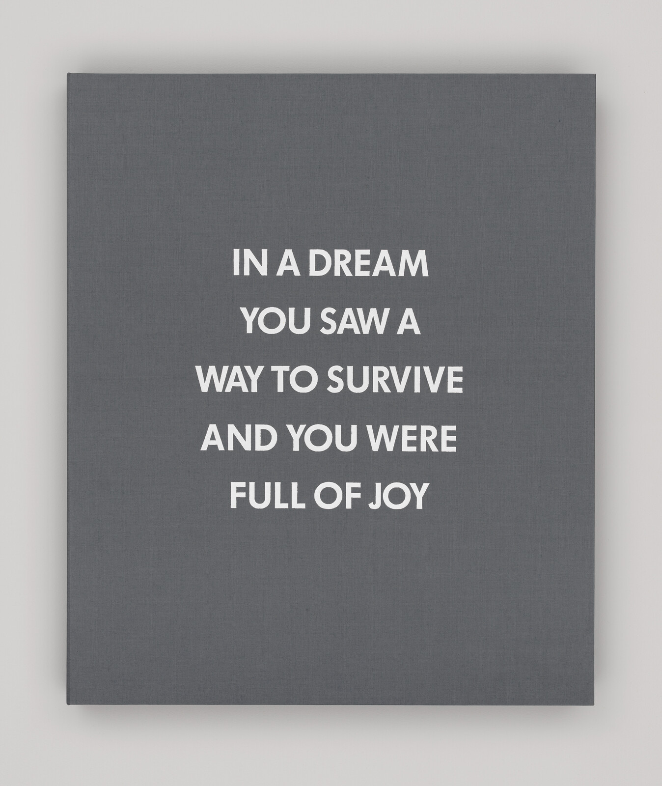 Gray canvas with white text: "IN A DREAM YOU SAW A WAY TO SURVIVE AND YOU WERE FULL OF JOY."