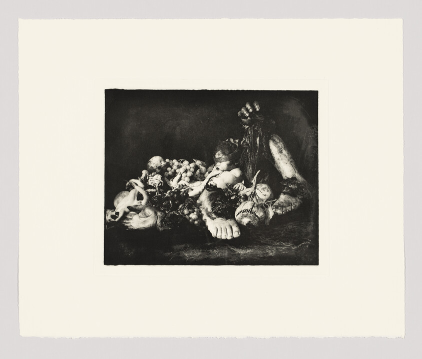 A dark still life arrangement with a doll, fruit, a skull, and a large foot placed together.