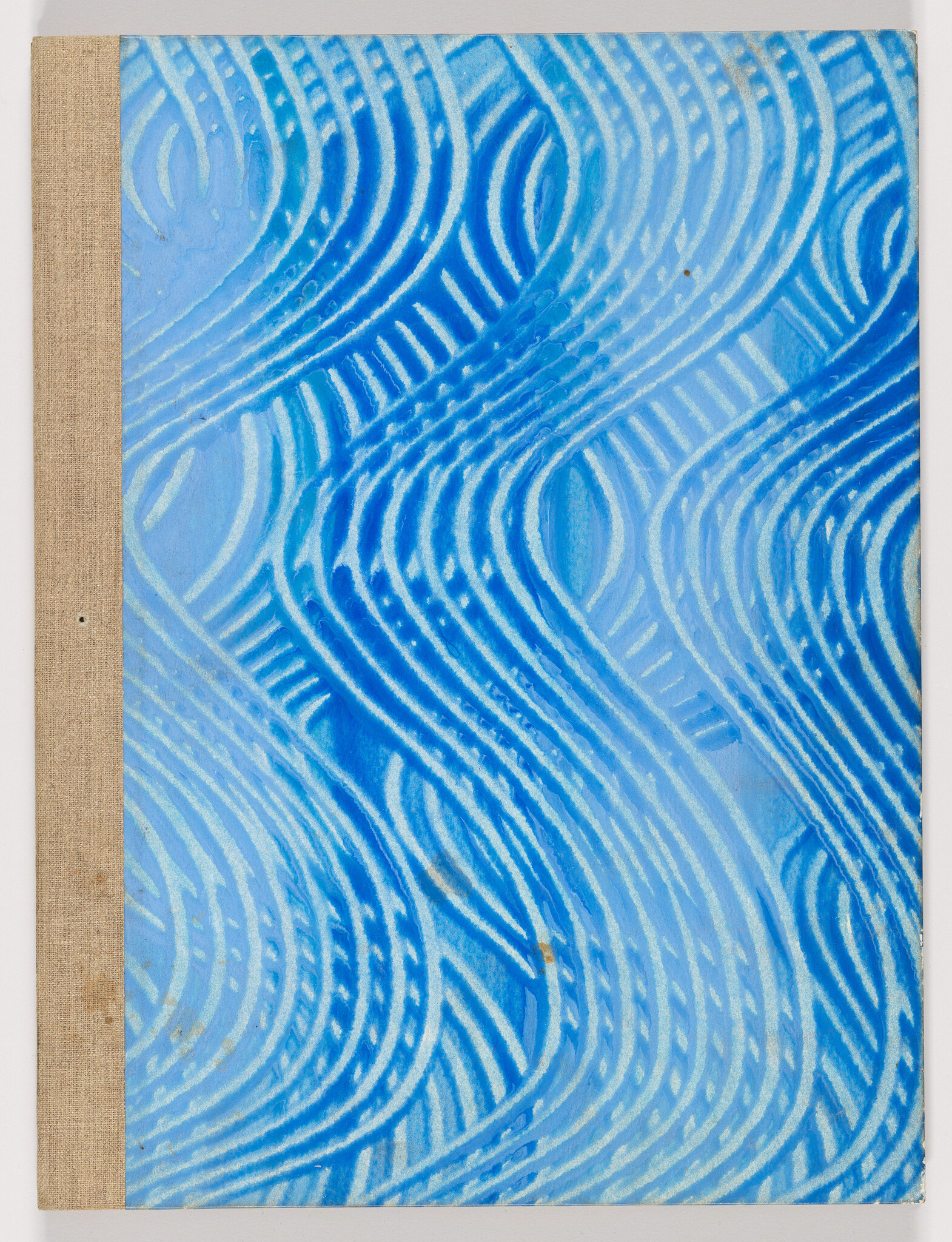 Blue book cover with flowing white and dark blue wavy lines and a beige cloth spine.