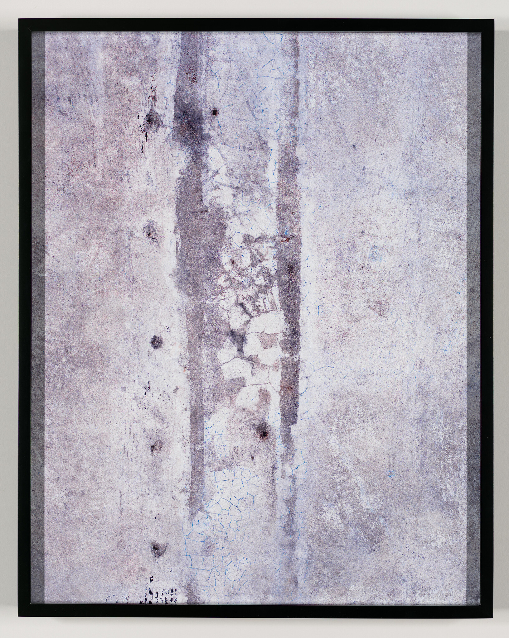 Framed abstract wall art showing vertical streaks, cracked peeling paint, and faded gray texture.