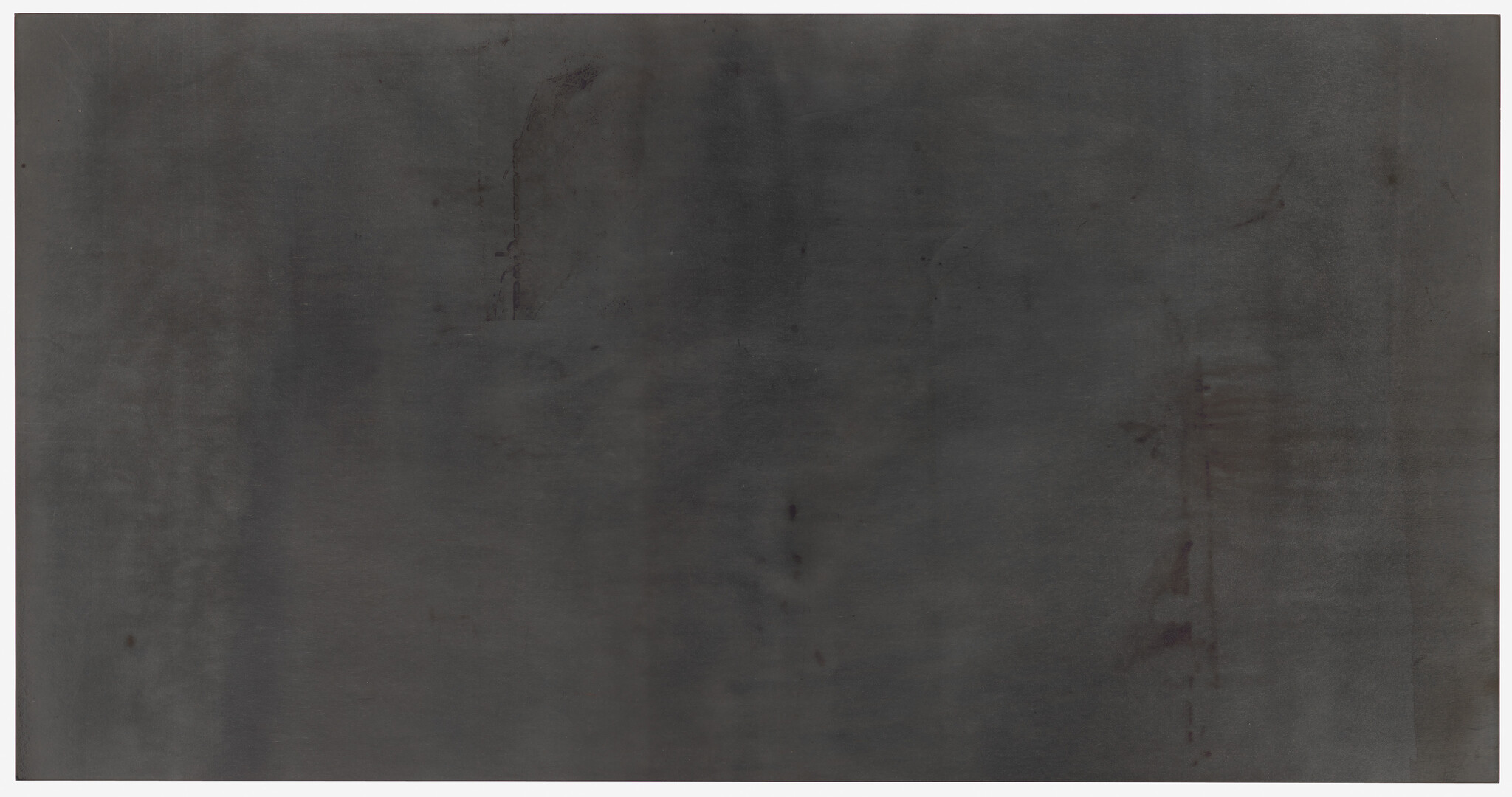 A large, monochromatic dark gray canvas with subtle variations in shade and a few indistinct marks and smudges throughout.