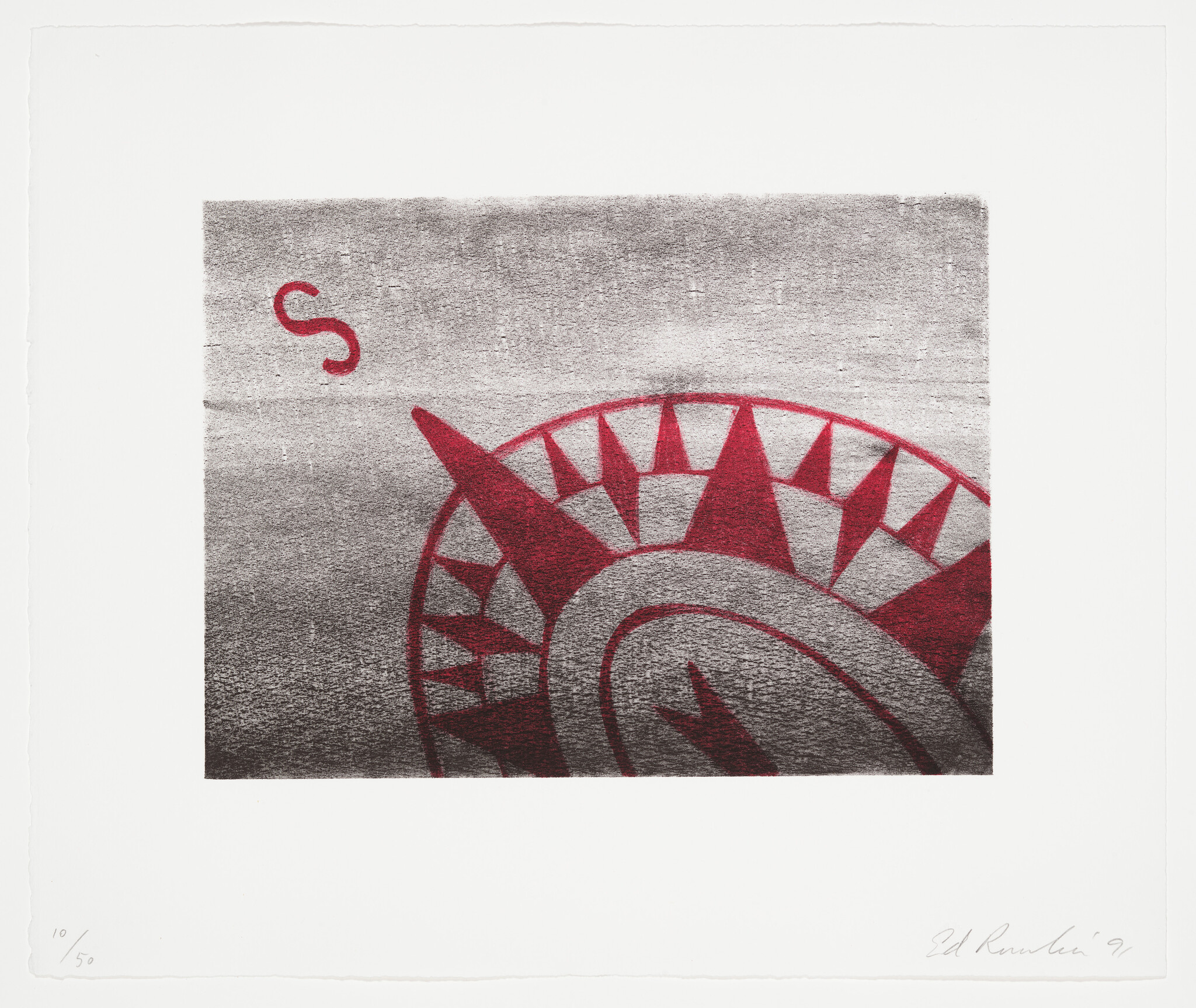 Partial red compass rose with an 'S' marker on a textured gray background.